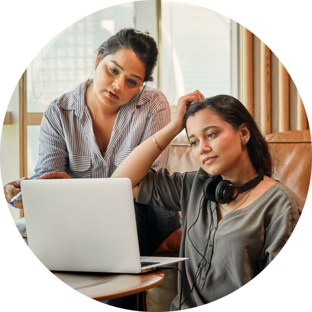 Two women using their laptop.