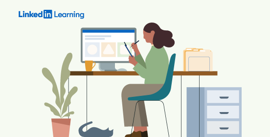women at desk with laptop and monitor