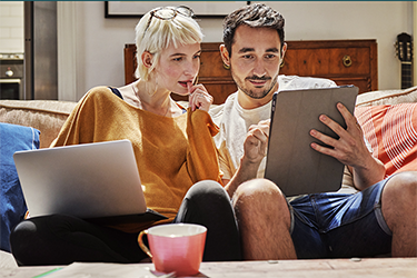 Picture of two people looking at a tablet screen