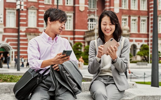 two people checking data on their smart phones