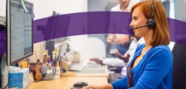 Image of woman with headset looking at screen