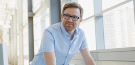 Man leaning on desk