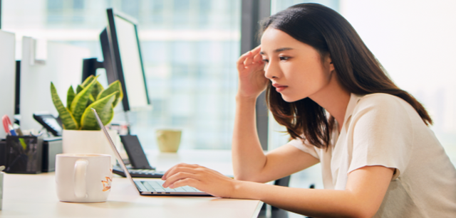 Image of a professional working on a laptop