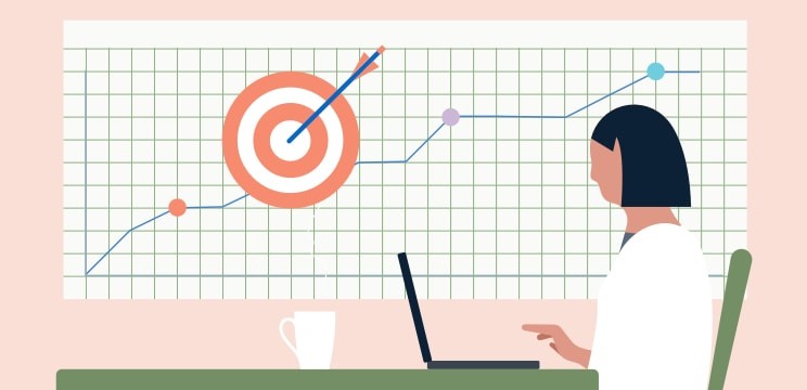 Woman working in front of a graph with bullseye on it
